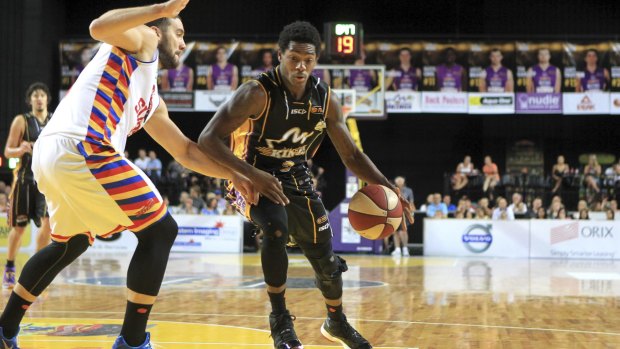 Guarded: Sydney playmaker Kendrick Perry tries to get past Adelaide.