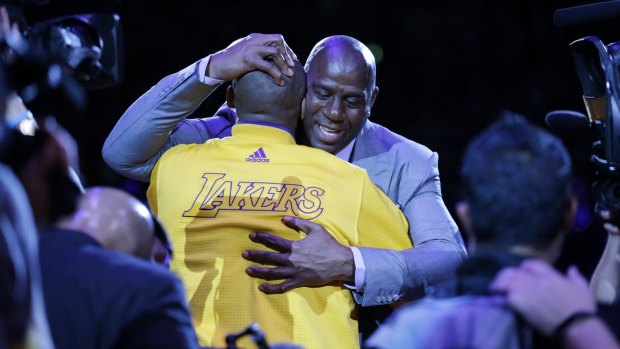 Los Angeles Lakers forward Kobe Bryant  hugs Magic Johnson.