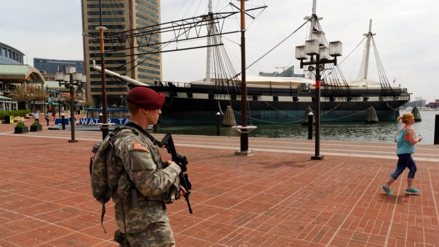 A National Guard trooper patrols Baltimore's harbour area.