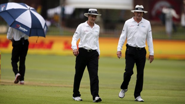 Umpires Billy Bowden and Paul Reiffel walk off the ground on day four of the Test after play was suspended due to rain. The rain continued on day five, leading to the match being drawn.