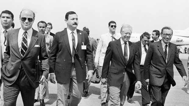Egyptian Minister for Foreign Affairs Boutros Boutros-Ghali, right, welcomes former US President Jimmy Carter at Cairo International Airport in 1987.