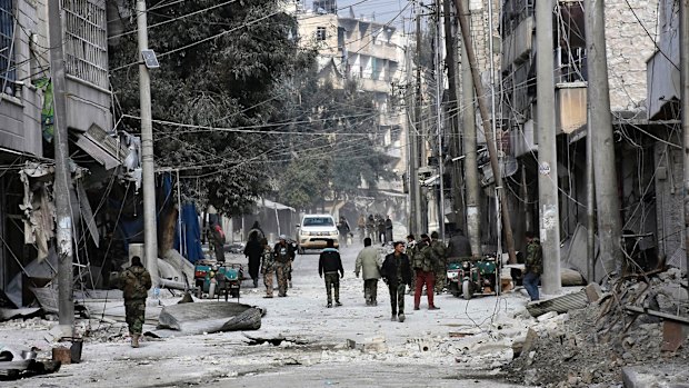 Syrian soldiers and civilians in east Aleppo on Monday in an image provided by the Syrian official news agency.