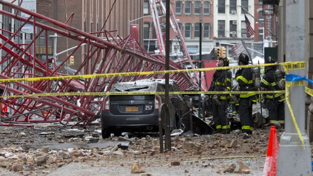 Firefighters work at the scene of a crane collapse in lower Manhattan.