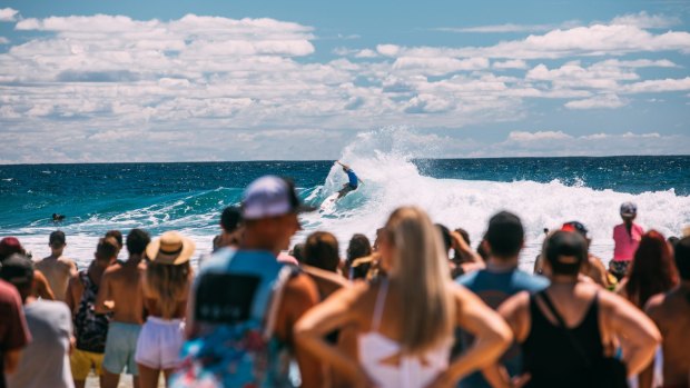 Surfing is in the blood: Visitors watch on at a surf competition.