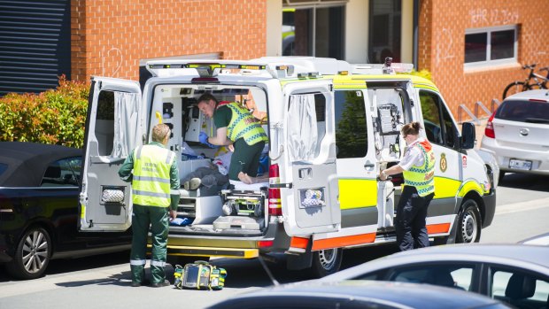 Paramedics treat students and teachers after an explosion between sugar and sulphuric acid in a year 9 class at Burgman Anglican School in Gungahlin.