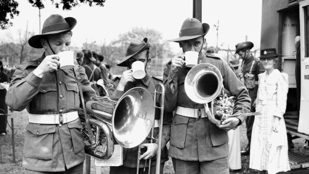 Bandsmen of the A.I.F. drink tea during a break while training at Sydney's Prince Alfred Park in 1942.