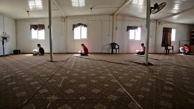 The tent city now features a mosque, where Syrian refugee boys sit, reading verses from the Koran. 