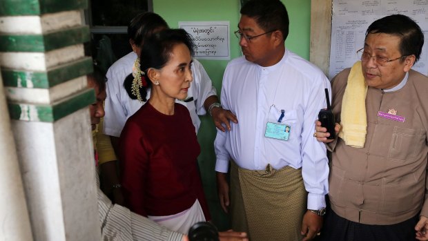 Myanmar Opposition Leader Aung San Suu Kyi arrives at a polling station to cast her vote.