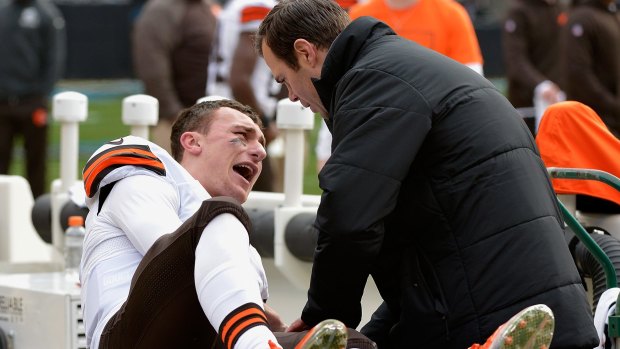 A trainer tends to Johnny Manziel.