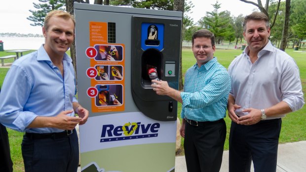 Environment minister Rob Stokes, Mark Coure and Nicholas Aroney with the machine that would cut down on plastics pollution.