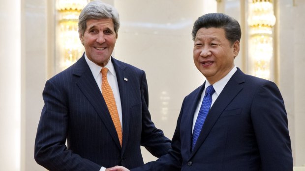 US Secretary of State John Kerry, left, poses with Chinese President Xi Jinping prior to their meeting at the Great Hall of the People in Beijing on January 27.