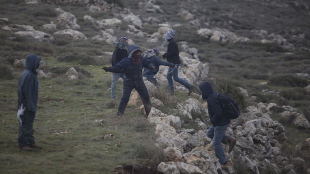 Settlers throw stones  at Israeli police in Amona, West Bank.