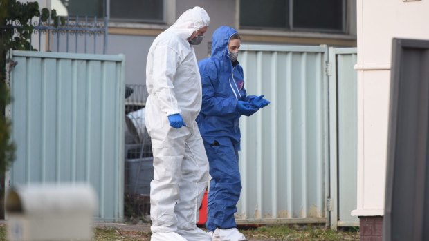 Forensic police examined the house on Danny Road in Lalor Park after a girl was shot dead.