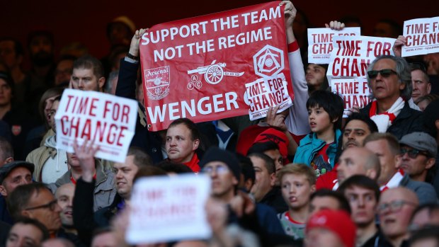 Unpopular: Arsenal supporters hold banners 'Time For Change' and a message for Arsene Wenger.