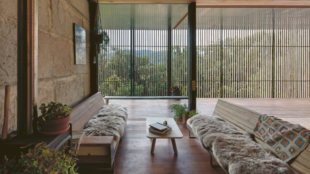 When closed, the sliding screens shelter the outdoor living area while still allowing light in and occupants to enjoy the outlook through the slats.