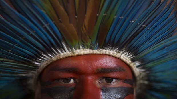 An indigenous man listens to speeches during a rally of Social Movements for Democracy, in a camp set up by supporters of President Dilma Rousseff in Brasilia on April 16.