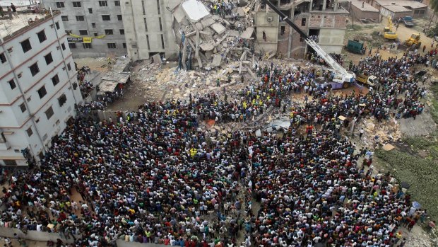 Bangladeshis gather to watch the rescue effort at the collapsed Rana Plaza building in Savar, near the capital Dhaka, in April 2013. 