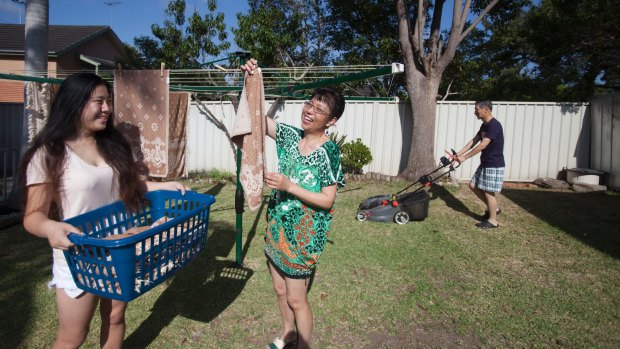Journalist Katherine O'Chee's family. Her sister Fiona and parents Henry and Jenny expects to be doing regular housework in the backyard on Christmas Day. Photo: Fiona Morris 