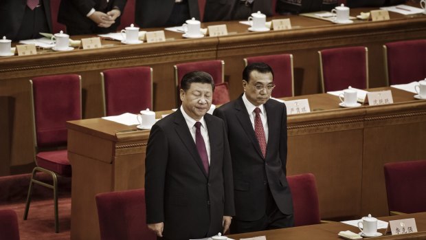 Xi Jinping, China's president, left, and Li Keqiang, China's premier, arrive during the opening of the fifth session of the 12th Chinese People's Political Consultative Conference (CPPCC) at the Great Hall of the People in Beijing, China, on March 3. 