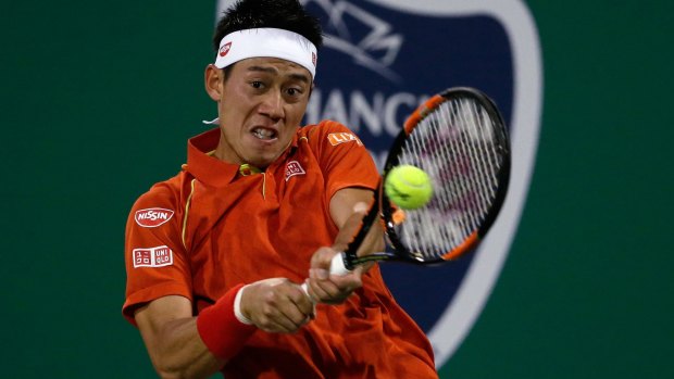 Kei Nishikori hits a return against Kevin Anderson of South Africa.