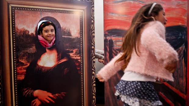 Transgender girls Selenna, right, and Genesis who poses inside a Mona Lisa painting, play during celebrations marking Transgender Children's Day in Santiago, Chile, last year.