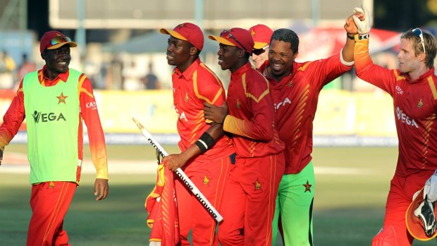 Boilover: Zimbabwean players and their coach, Makhaya Ntini celebrate winning the T20 international against India at Harare Sports Club.