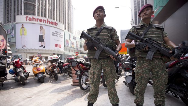 Soldiers stand guard before the arrival of Malaysian Prime Minister Najib Razak for a joint police-army exercise in downtown Kuala Lumpur on Monday.