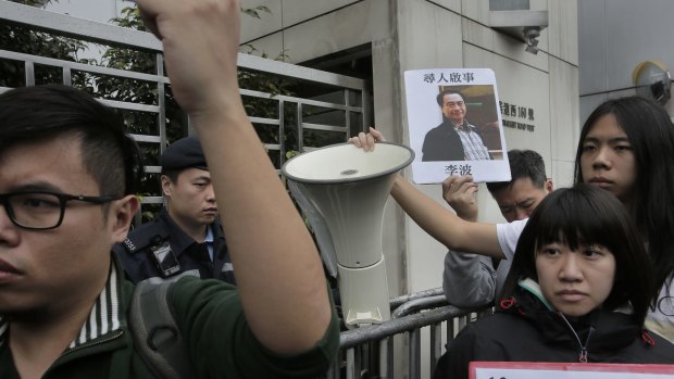 A protester with  a photo of missing bookseller Lee Bo in Hong Kong on Sunday.