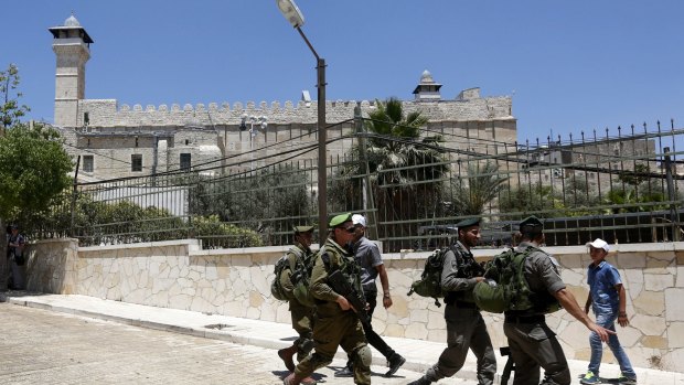 Israeli soldiers outside the site known to Muslims as the Ibrahimi Mosque and to Jews as the Cave of the Patriarchs.  