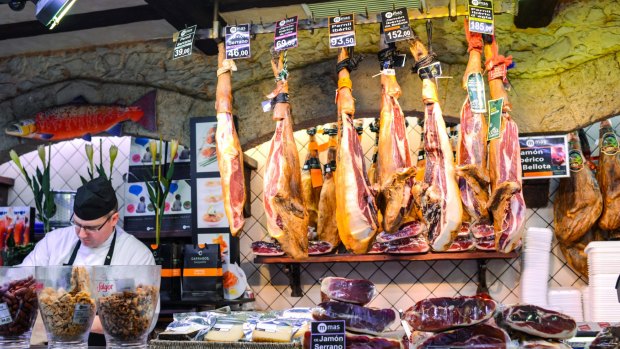 Divine jamon: Serrano and Iberian ham at La Boqueria food market, Barcelona, Spain. 