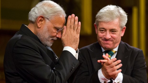 Indian Prime Minister Narendra Modi acknowledges applause next to John Bercow after addressing MPs and invited guests in the Royal Gallery at the Houses of Parliament  in November 2015.