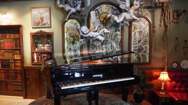 A piano in the Walled Off Hotel (owned by Bansky) near the wall of separation in Bethlehem. 