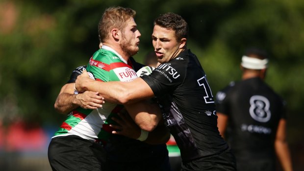 Brothers in arms: Tom is tackled by Sam Burgess during a South Sydney Rabbitohs training session at Redfern Oval.