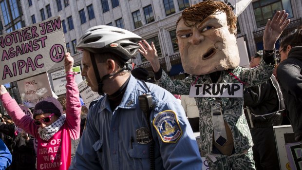 A police officer watches as protesters demonstrate against Donald Trump outside the American Israeli Public Affairs Committee (AIPAC) policy conference in Washington, on Monday.