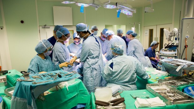 Surgeons and medical staff during an operation at the Queen Elizabeth Hospital Birmingham, UK, part of the NHS, earlier this year.