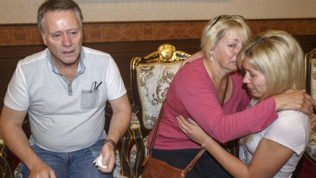 Grieving: Hannah Witheridge's family at the headquarters of the Royal Thai Police in Bangkok last year.