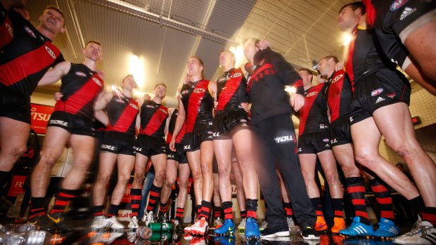 Victorious: Essendon players in the rooms after their narrow win over Melbourne on Saturday.