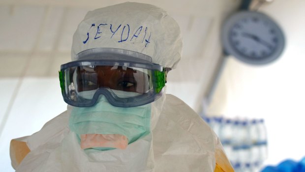 A Liberian health worker helps at the Medecins Sans Frontieres Ebola treatment centre in Monrovia, Liberia.