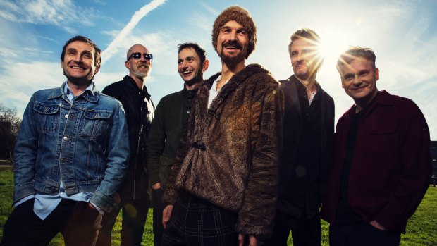 British band James, with Jim Glennie, third from left, and frontman Tim Booth, fourth from left. 