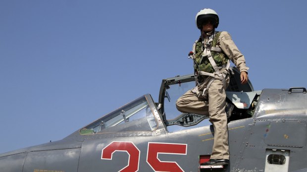 Russian army pilot poses on the cockpit of SU-25M jet fighter - the same type of fighter that was shot down by Turkey - at Hmeimim airbase in Syria in October. 