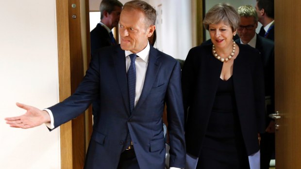 Donald Tusk, left, leads British Prime Minister Theresa May  to a bilateral meeting on the sidelines of an EU summit in Brussels.