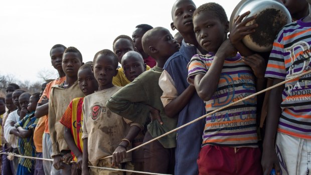 South Sudanese children wait for food at the Bidi Bidi refugee camp over the border in Uganda.
