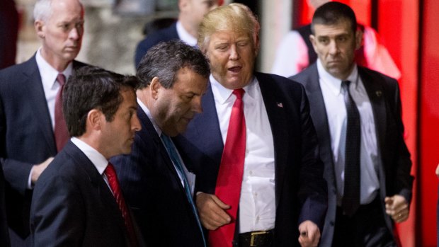 Republican presidential candidate Donald Trump, center right, speaks with New Jersey Governor Chris Christie, center left, following a rally at Millington Regional Airport in Tennessee, on Saturday.