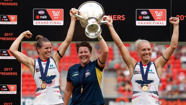 Chelsea Randall, Bec Goddard and Erin Phillip hold the cup aloft after the Crows won the inaugural AFLW Premiership.