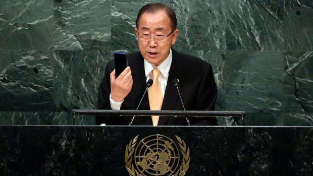 UN Secretary General Ban Ki-moon raises his mobile phone as he addresses the 71st session of the United Nations General Assembly on Tuesday.