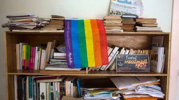 An LGBTI pride flag hangs on a bookshelf by a Massimadi festival poster, right, in the festival organiser's office in Port-au-Prince, Haiti on Tuesday. The four-day film and art event was called off due to threats of violence.