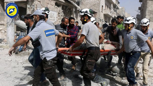 Rescue workers work the site of air strikes in Aleppo.