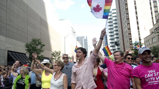 Ontario Premier Kathleen Wynne, Prime Minister Justin Trudeau and Toronto mayor John Tory wave to spectators at the annual Pride Parade.