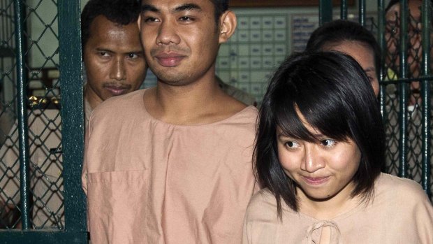 Patiwat Saraiyaem, 23, and Porntip Mankong, 26, leave Bangkok's Criminal Court after being sentenced on charges of lese majeste.