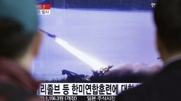 South Koreans watch a TV broadcast on March 18 showing file footage of a missile launch conducted by North Korea.